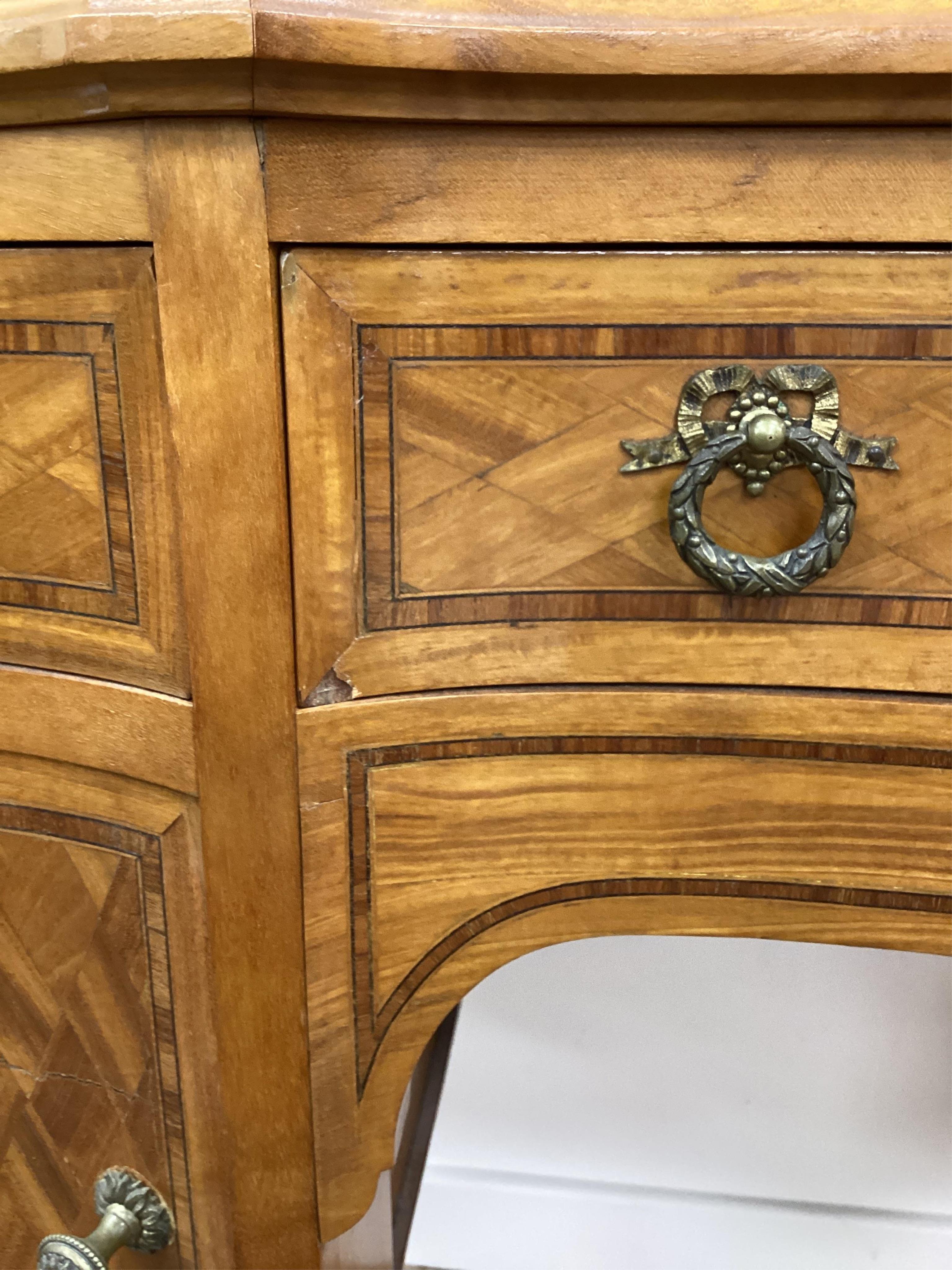 An early 20th century French transitional style gilt metal mounted tulip banded and parquetry inlaid kneehole dressing table, width 115cm, depth 50cm, height 160cm